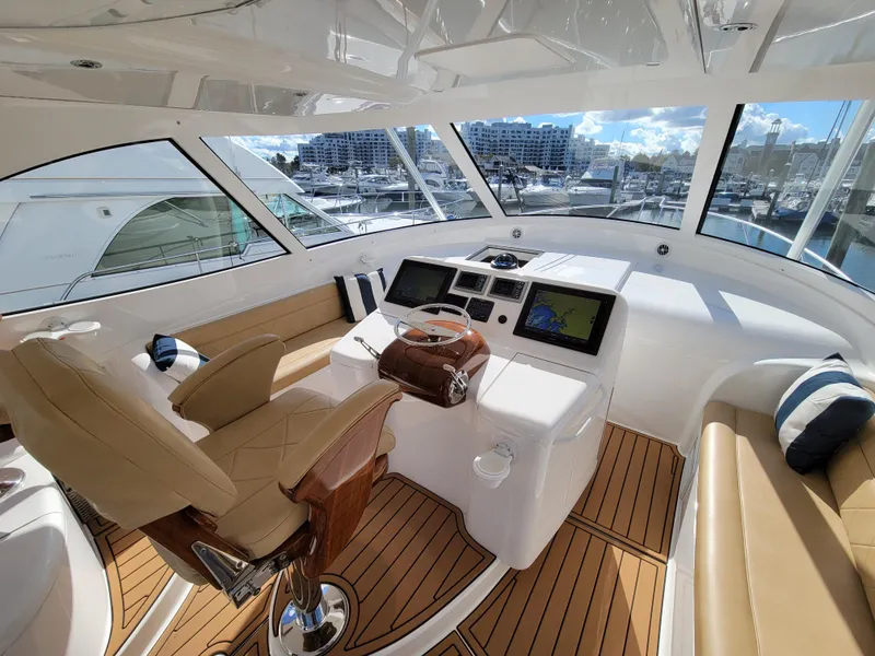 Slide: The Image of Luxurious 2016 Viking 42 Sport Tower yacht interior with modern helm and plush seating. - 10