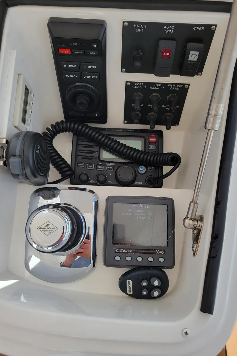 Slide: The Image of Control panel of a 2016 Viking 42 Sport Tower with navigation and communication equipment. - 13