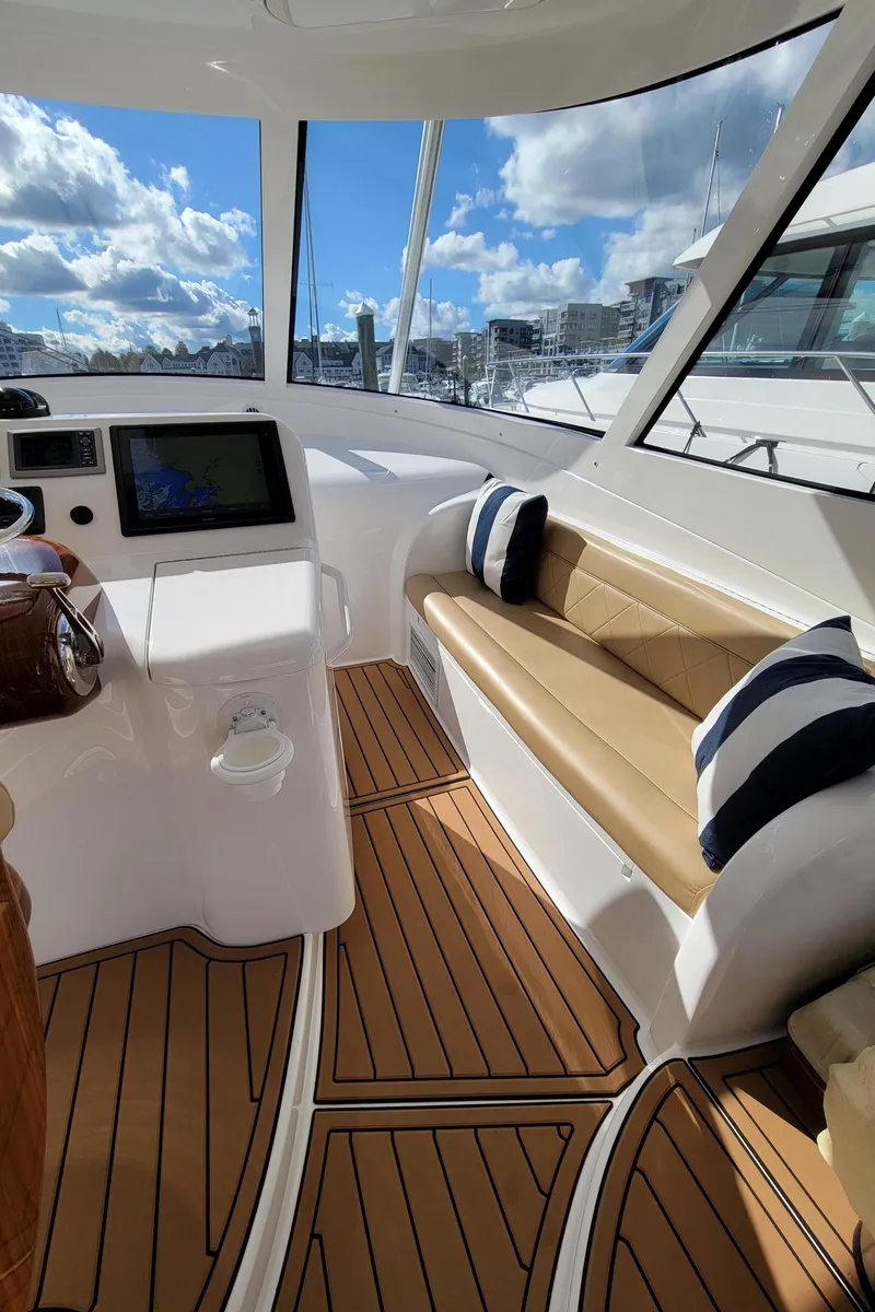 Slide: The Image of 2016 Viking 42 Sport Tower interior with plush seating and modern navigation system. - 15