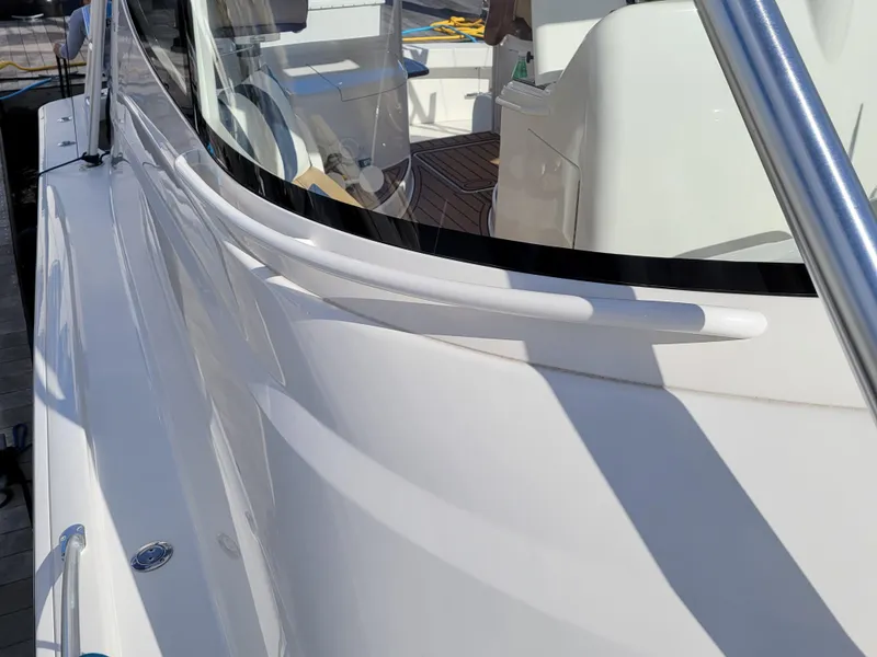 Slide: The Image of 2016 Viking 42 Sport Tower yacht, sleek white exterior, close-up view. - 18