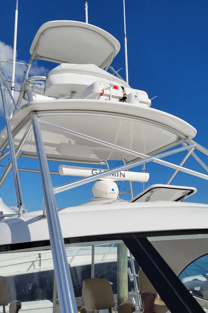Slide: The Image of 2016 Viking 42 Sport Tower yacht with tower and radar against blue sky. - 19