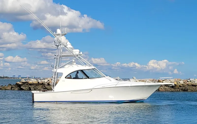 Slide: The Image of 2016 Viking 42 Sport Tower yacht on calm water, clear sky background. - 2