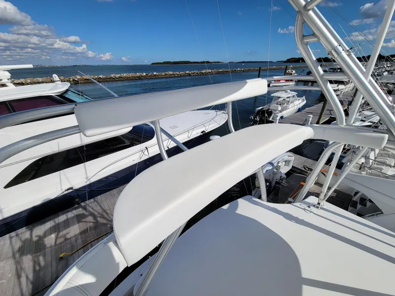 Slide: The Image of 2016 Viking 42 Sport Tower yacht docked at marina, clear sky, ocean view. - 21