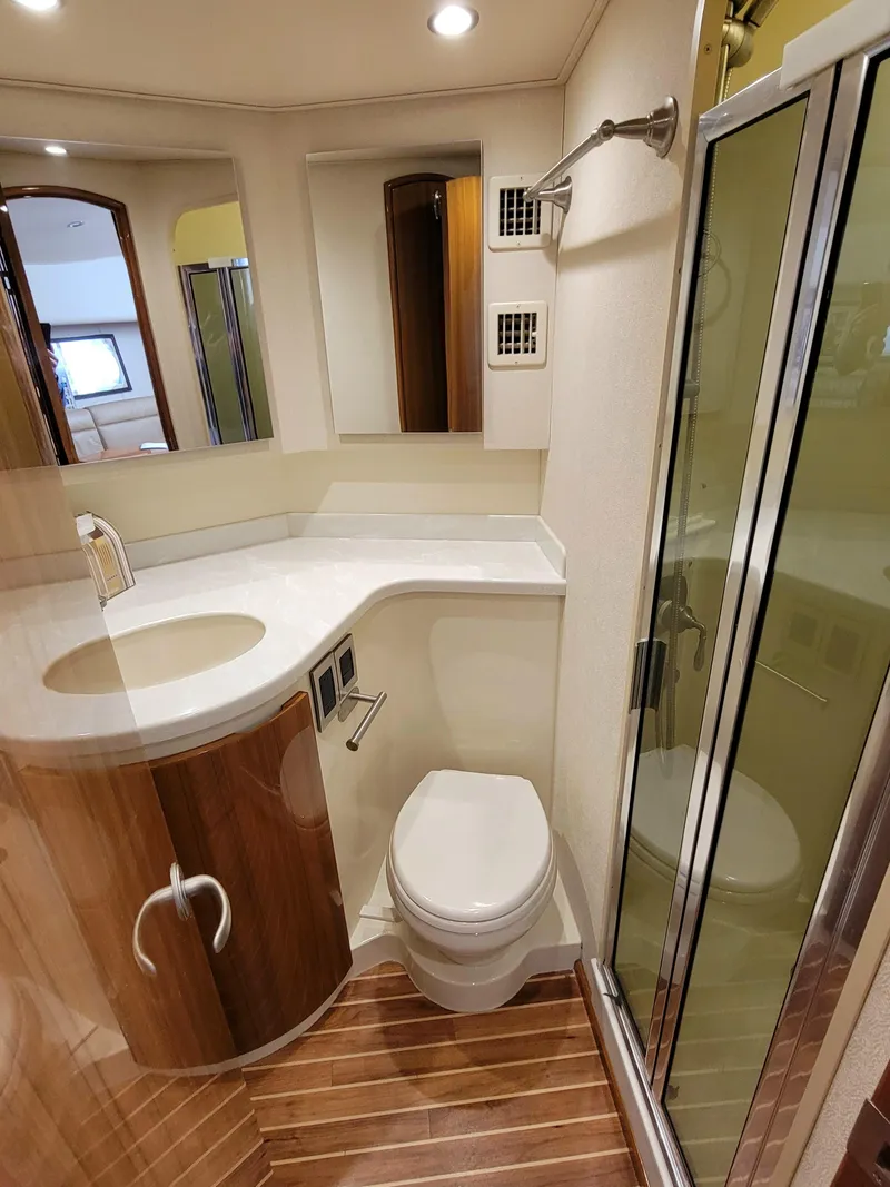 Slide: The Image of Luxurious bathroom in 2016 Viking 42 Sport Tower yacht with modern fixtures and wood accents. - 28