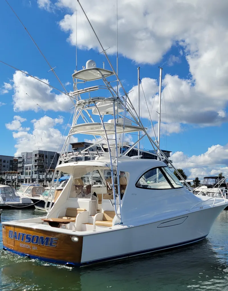 Slide: The Image of 2016 Viking 42 Sport Tower yacht docked under a blue sky. - 3