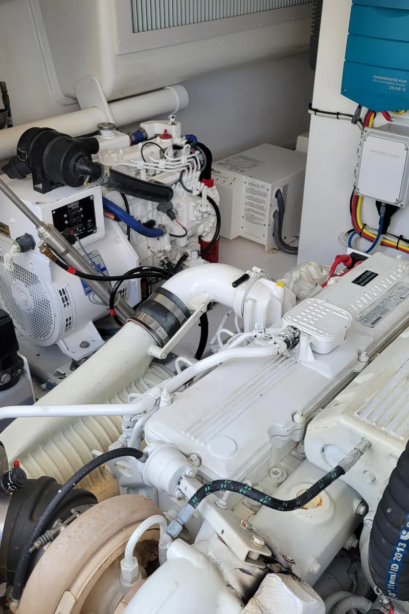 Slide: The Image of Engine room of 2016 Viking 42 Sport Tower with visible machinery and wiring. - 32