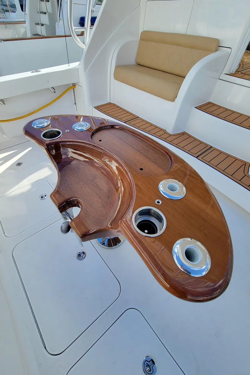Slide: The Image of 2016 Viking 42 Sport Tower cockpit with wooden fishing station and seating area. - 7