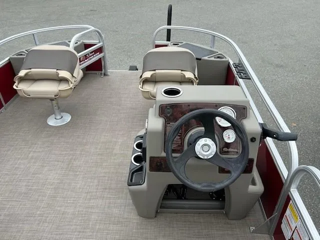 Slide: The Image of 2024 Sun Tracker Bass Buggy 18 DLX pontoon boat interior with steering console and seating. - 4