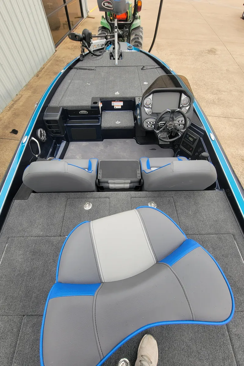 Slide: The Image of 2024 Triton 19 TrX fishing boat interior with modern dashboard and seating. - 2