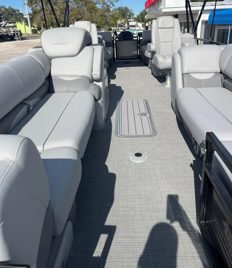 Slide: The Image of 2024 Regency 230 DL3 pontoon boat with spacious seating and modern interior. - 3