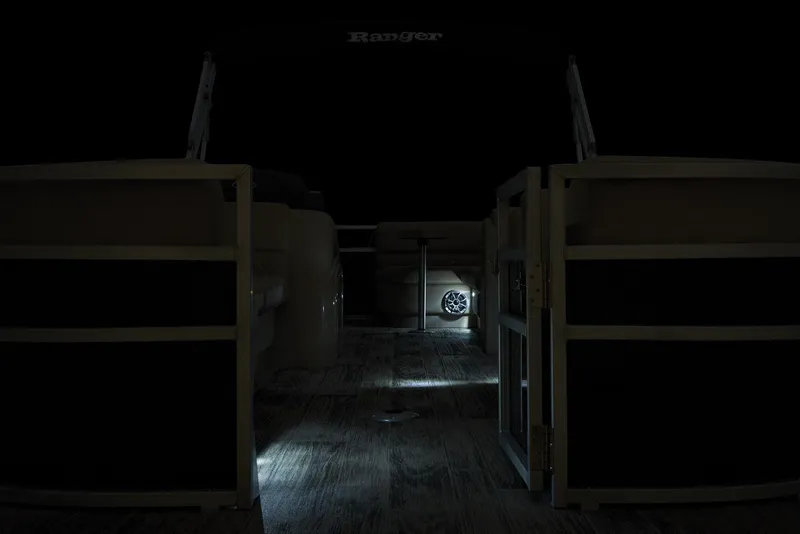 Slide: The Image of 2024 Ranger Reata 220C boat interior with ambient lighting at night. - 13