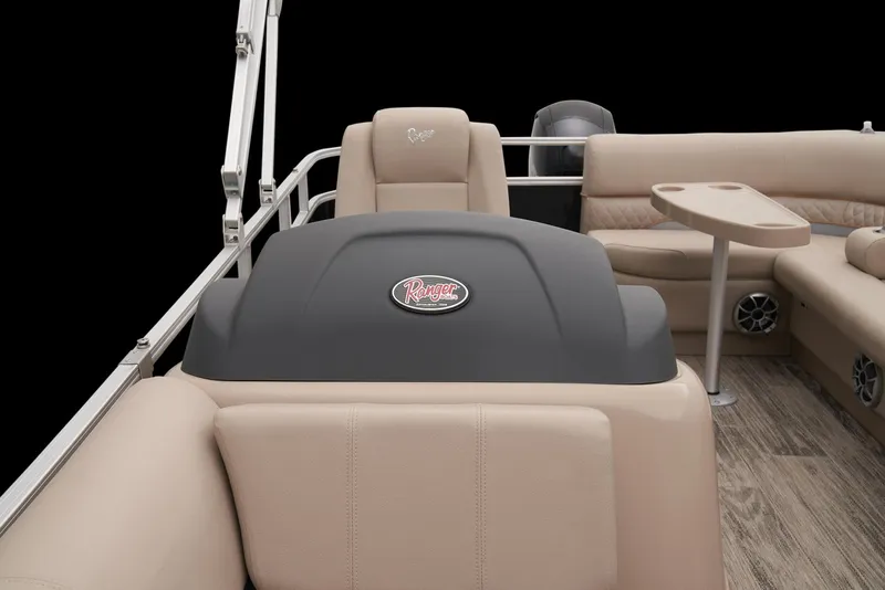 Slide: The Image of 2024 Ranger Reata 220C boat interior with beige seating and table. - 18
