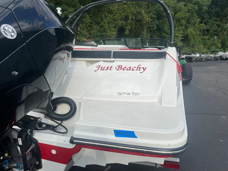 Slide: The Image of 2021 Sea Ray SPX 230 boat with "Just Beachy" text on the stern. - 3