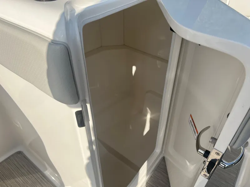 Slide: The Image of 2021 Sea Ray SPO 230 boat storage compartment with open door. - 8