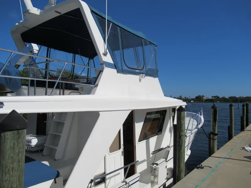 Slide: The Image of 2010 DeFever 48 Offshore yacht docked at a marina on a sunny day. - 11