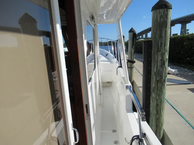 Slide: The Image of 2010 DeFever 48 Offshore yacht docked, side deck view. - 12