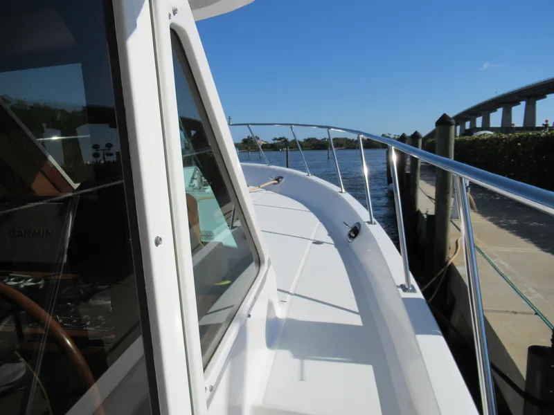 Slide: The Image of DeFever 48 Offshore 2010 yacht docked by a waterfront on a sunny day. - 13