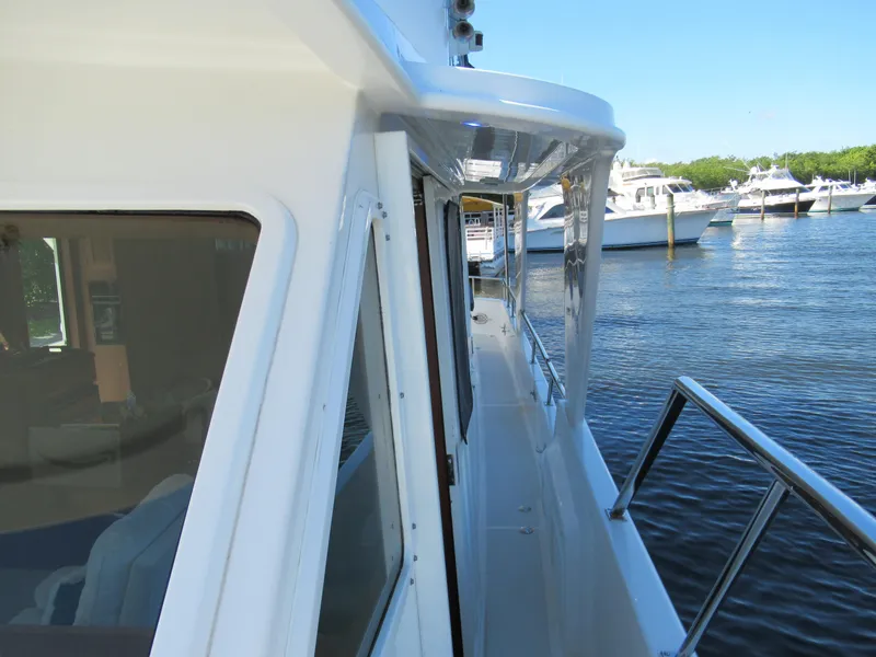 Slide: The Image of 2010 DeFever 48 Offshore yacht side deck view at marina. - 18