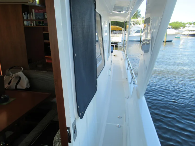 Slide: The Image of DeFever 48 Offshore 2010 yacht side deck with marina view. - 19