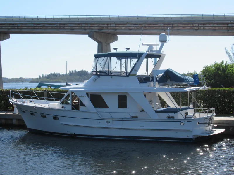 Slide: The Image of 2010 DeFever 48 Offshore yacht docked near a bridge. - 2