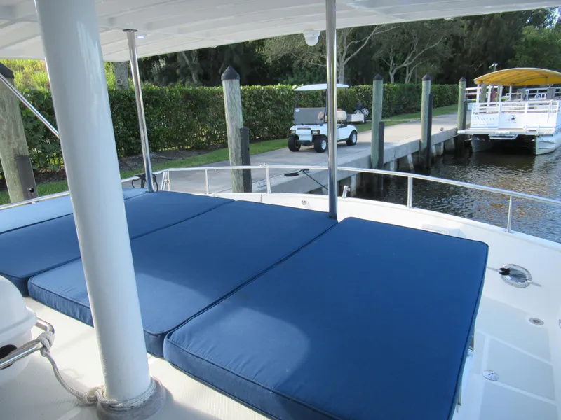 Slide: The Image of 2010 DeFever 48 Offshore yacht with blue deck cushions docked at marina. - 21
