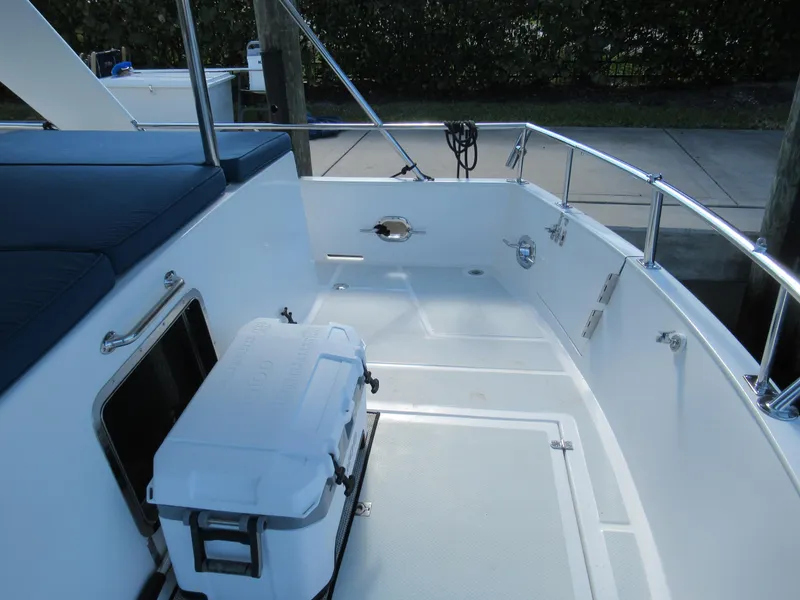Slide: The Image of DeFever 48 Offshore 2010 boat deck with cooler and seating area. - 23