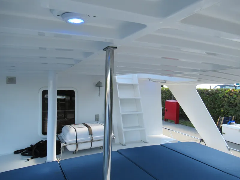 Slide: The Image of DeFever 48 Offshore 2010 yacht interior with blue seating and white ladder. - 24