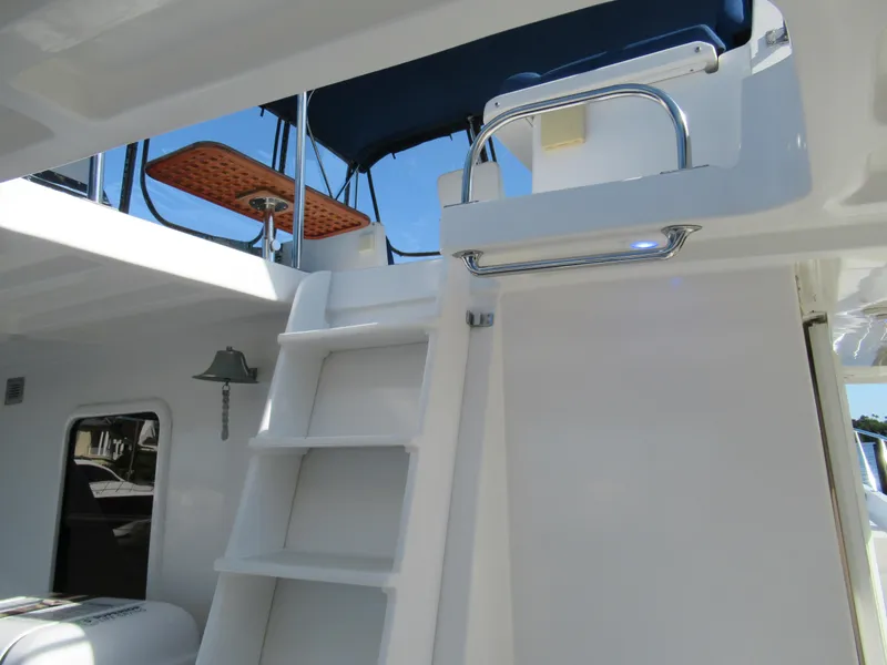 Slide: The Image of DeFever 48 Offshore 2010 yacht with ladder to upper deck and blue canopy. - 27