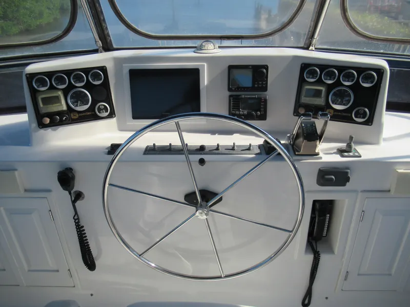 Slide: The Image of DeFever 48 Offshore 2010 yacht helm with navigation instruments and steering wheel. - 30
