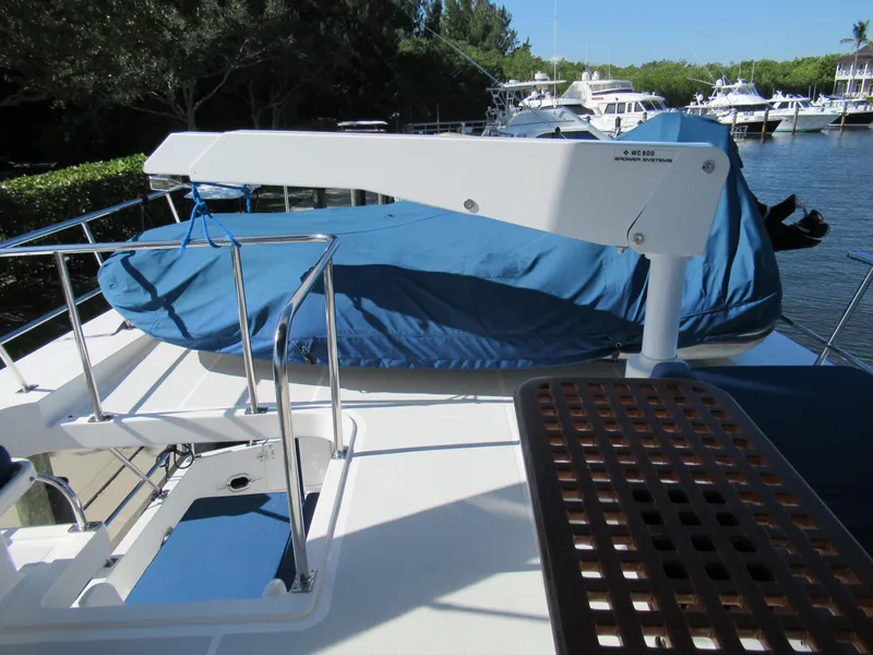Slide: The Image of DeFever 48 Offshore 2010 yacht deck with covered equipment and davit crane. - 34