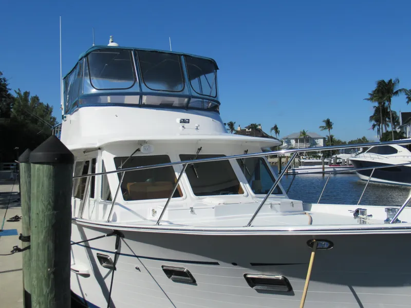 Slide: The Image of 2010 DeFever 48 Offshore yacht docked at a marina on a sunny day. - 4
