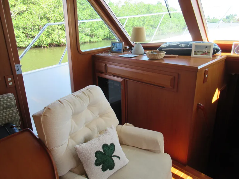 Slide: The Image of Cozy interior of 2010 DeFever 48 Offshore yacht with armchair and shamrock pillow. - 40