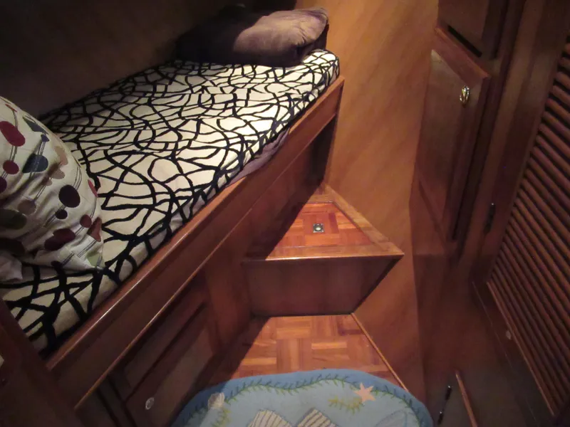 Slide: The Image of Interior cabin of a 2010 DeFever 48 Offshore yacht with a patterned bed. - 45