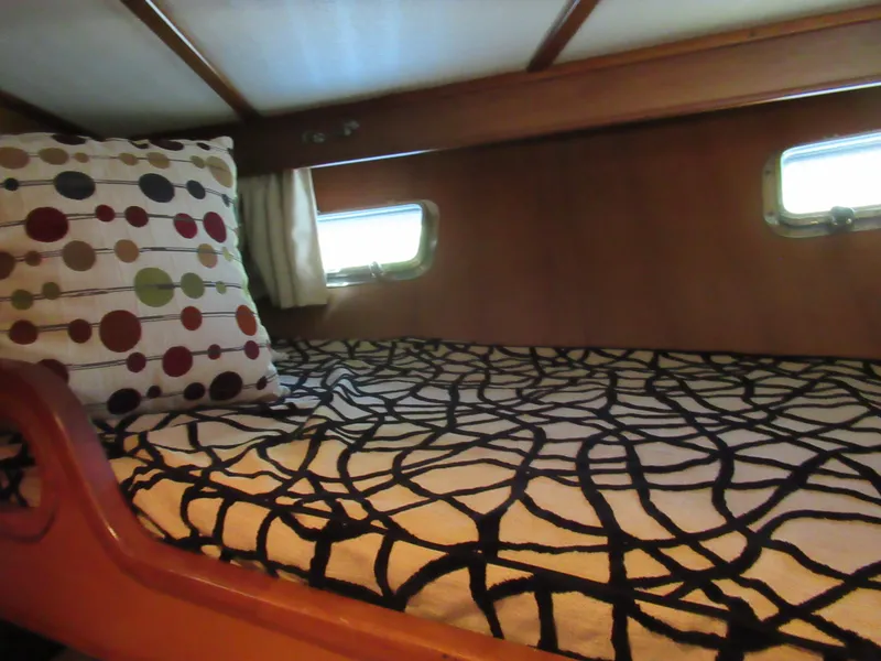 Slide: The Image of Cozy cabin bed in 2010 DeFever 48 Offshore yacht with patterned bedding. - 47