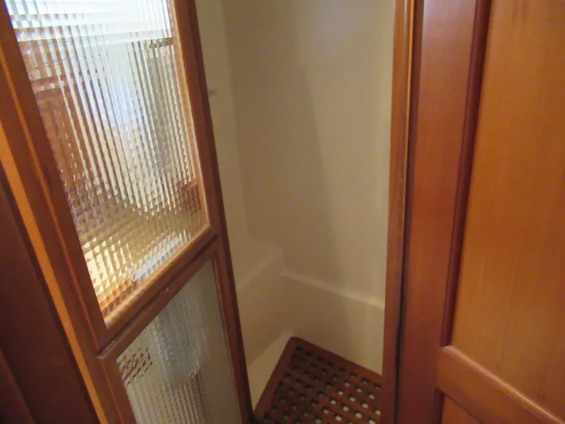 Slide: The Image of 2010 DeFever 48 Offshore yacht shower with wooden grate flooring and frosted glass door. - 48