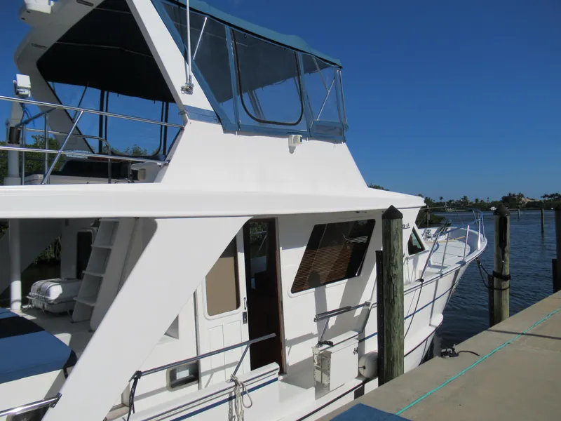 Slide: The Image of 2010 DeFever 48 Offshore yacht docked at a marina on a sunny day. - 6
