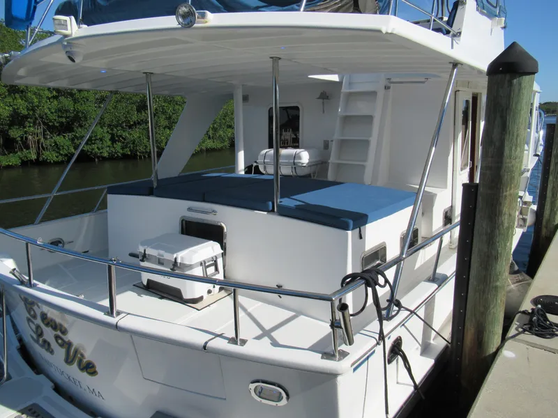 Slide: The Image of 2010 DeFever 48 Offshore yacht docked, rear view with seating and storage. - 7