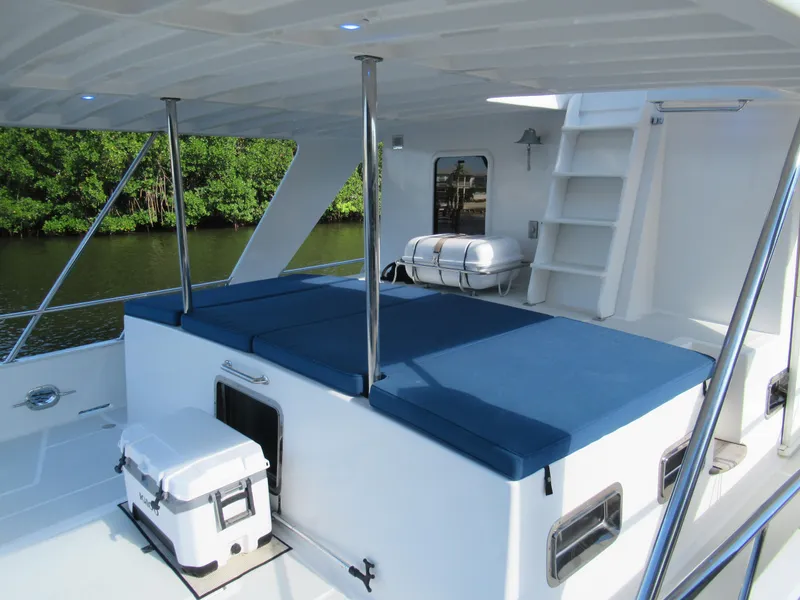 Slide: The Image of DeFever 48 Offshore 2010 yacht deck with blue cushions and white cooler. - 9