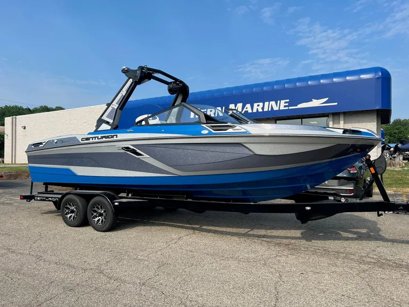 Slide: The Image of 2024 Centurion Ri245 boat on trailer outside dealership. - 0