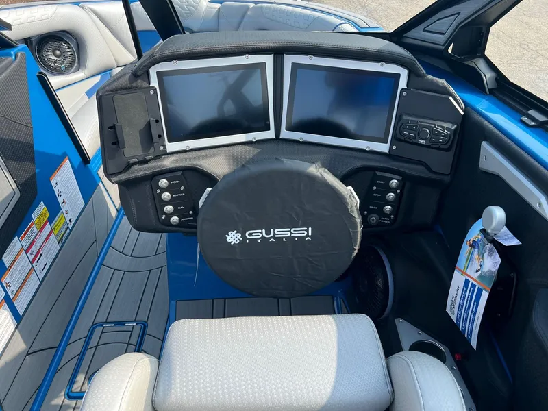 Slide: The Image of 2024 Centurion Ri245 boat dashboard with dual screens and Gussi Italia steering wheel. - 7