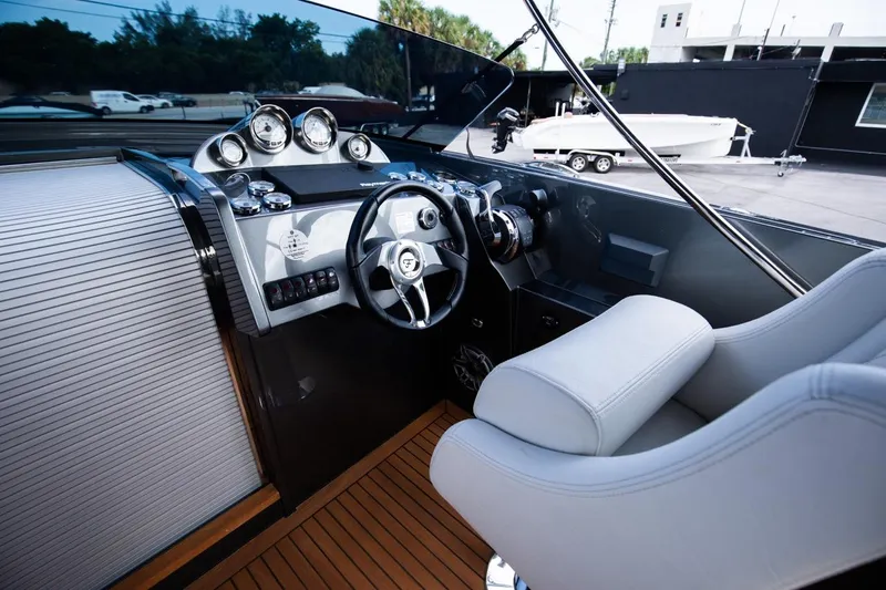 Slide: The Image of 2020 Frauscher 1017 GT boat cockpit with modern steering wheel and dashboard. - 10