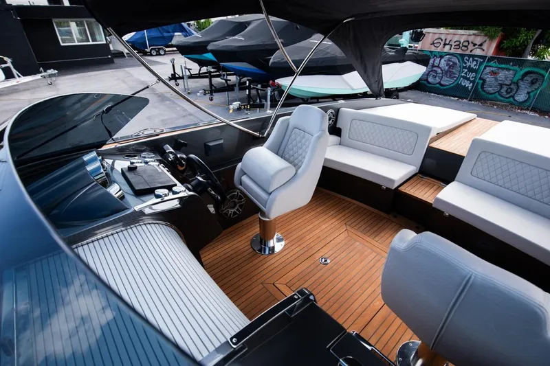 Slide: The Image of 2020 Frauscher 1017 GT luxury boat interior with teak flooring and white leather seating. - 12