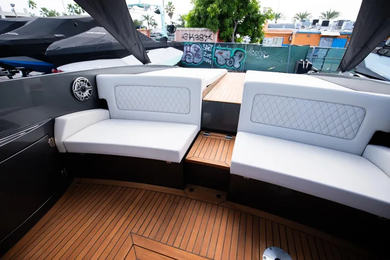 Slide: The Image of 2020 Frauscher 1017 GT boat interior with white cushioned seating and teak flooring. - 13