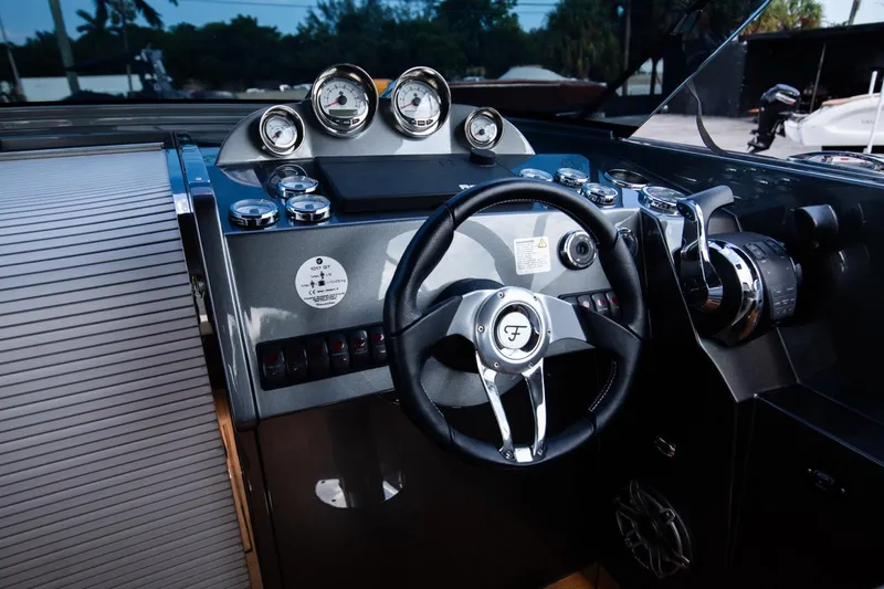 Slide: The Image of Frauscher 1017 GT 2020 boat dashboard with steering wheel and gauges. - 14