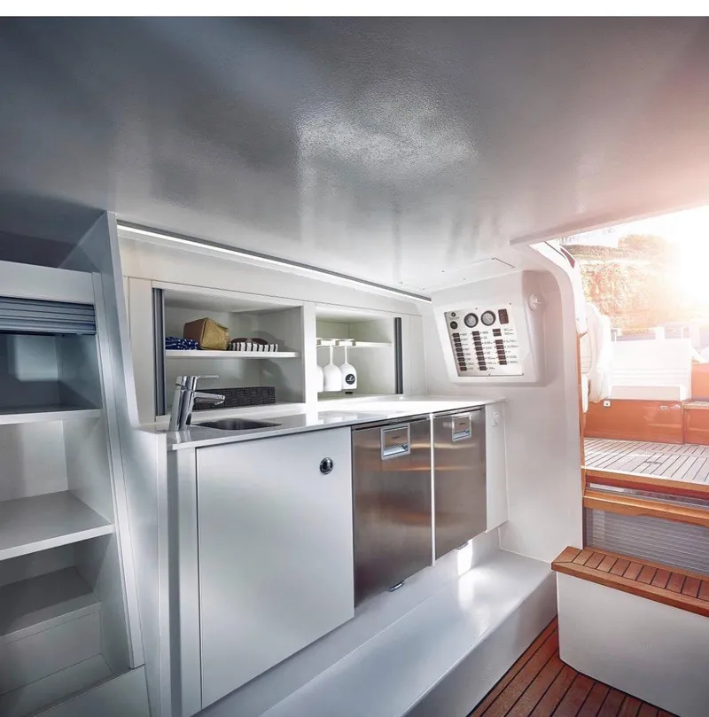 Slide: The Image of Interior of 2020 Frauscher 1017 GT yacht with modern kitchen amenities. - 16