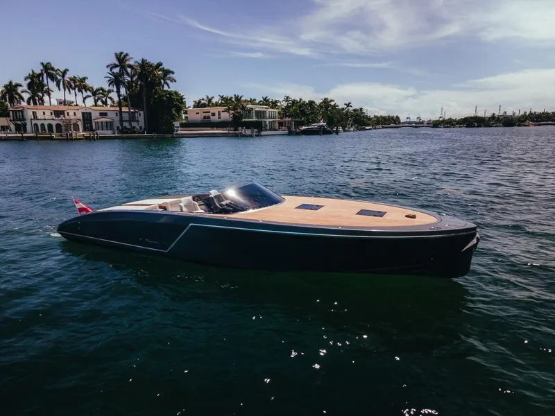 Slide: The Image of 2020 Frauscher 1017 GT luxury yacht cruising near waterfront homes. - 3