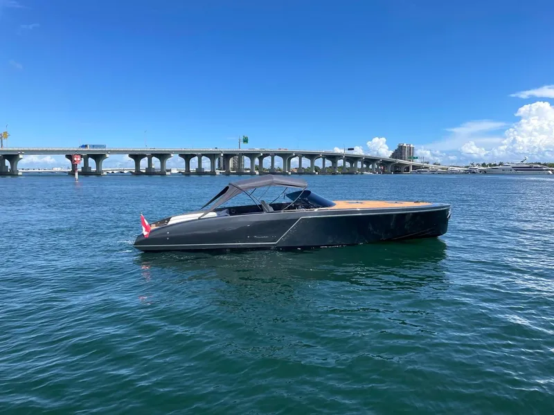 Slide: The Image of 2020 Frauscher 1017 GT luxury boat on water near a bridge. - 8