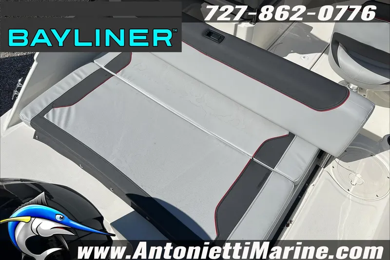 Slide: The Image of 2024 Bayliner Element M19 boat interior with seating, logo, and contact information. - 13