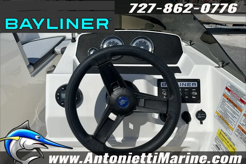 Slide: The Image of 2024 Bayliner Element M19 boat dashboard with steering wheel and controls, Antonietti Marine branding. - 18