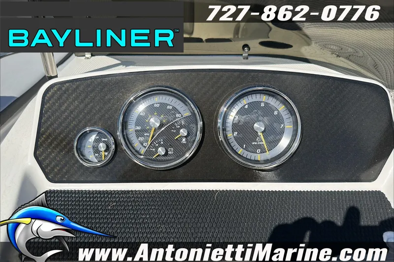 Slide: The Image of Dashboard of 2024 Bayliner Element M19 boat with gauges and branding. - 19